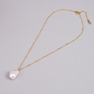 Elegant 18K gold-plated necklace featuring an irregular baroque pearl on a light background