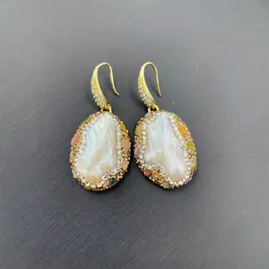 Macro detail of Baroque pearl drop earrings with Czech rhinestones and colorful crystals