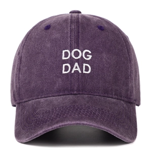 Close-up detail of a purple washed cotton baseball cap with white Dog Dad embroidery