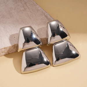 Macro view of geometric trapezoid silver earrings with a high-polished mirror finish