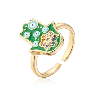 Macro detail of Hamsa Hand ring with green enamel, evil eye, and colorful zircons