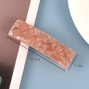 Macro view of pink stone texture acrylic spring hair clip with 8.5cm size markings