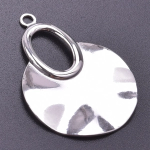 Macro shot of silver hammer-textured geometric pendant with smooth oval connection ring