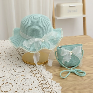 Detail of mint green straw hat and bag set with organza bows and pearls for girls