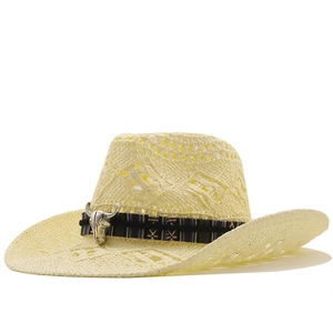 Close-up of beige straw cowboy hat with ethnic woven band and silver bull skull ornament