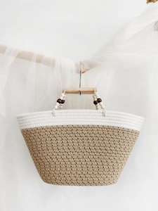 Handwoven cotton rope tote bag with wooden handles for summer beach vacations