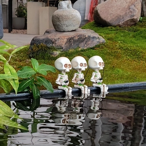 Three skeleton fishing resin statues by a mossy pond with realistic water reflections