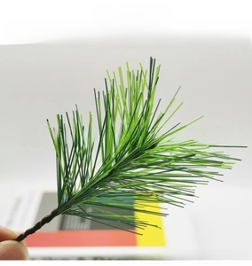Macro detail of artificial pine needles showing natural gradient and textured brown stem