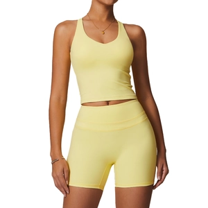 Women's bright yellow cross back yoga vest and high waisted sports shorts set