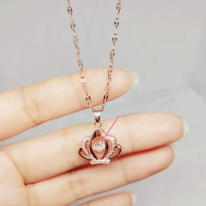 Detailed view of rose gold crown pendant featuring a dancing stone and pavé zircons