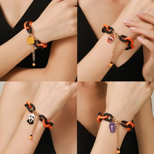 Detail view of four Halloween bracelets featuring pumpkin, lips, mask and coffin charms