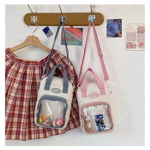 Detail of cute ITA bags with transparent PVC windows and blue or pink woven handles