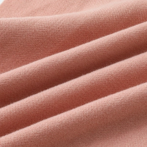 Pink double-sided cashmere-like scarf with soft knitted texture and detailed weave patterns