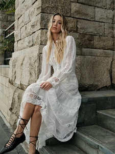 Elegant white French-style lace maxi dress with long sleeves and hollow-out design outdoors