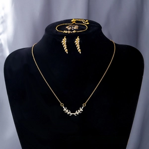 Detail of leaf-shaped jewelry set including necklace and earrings on black display