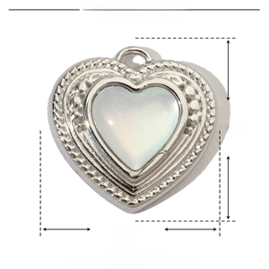 Macro shot of 15mm heart-shaped pendant made of stainless steel and white shell inlay