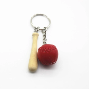 Detailed view of mini wooden baseball bat and red ball keychain with metal ring