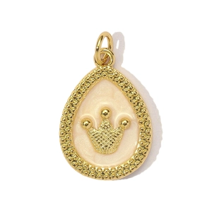 Macro detail of gold crown drop pendant with cream enamel finish and beaded edge detail