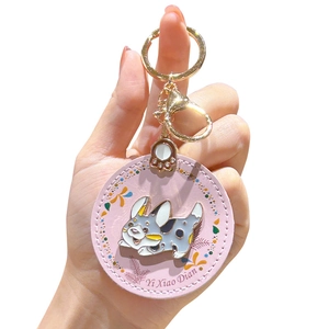Pink faux leather Corgi puppy keychain with golden clasp and paw charm held in hand