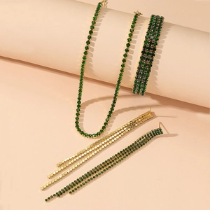 Detailed view of emerald green rhinestone jewelry set including necklace, bracelet and earrings