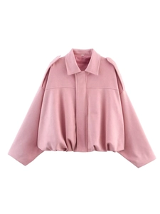 Detailed close-up of pink suede bomber jacket featuring lapel collar and elastic hem