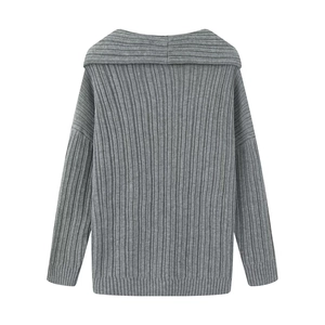 Close-up of grey long-sleeve knit sweater with vertical texture and off-shoulder neckline