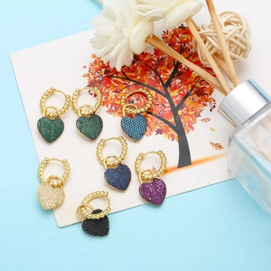 Detail showing various colors of heart-shaped earrings with micro-inlaid stones and gold clasps