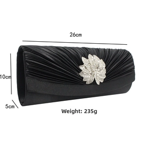 Detail of black satin pleated evening bag with floral rhinestone clasp and dimensions