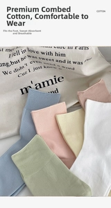 Detail of colorful cotton mid-calf socks in pastel colors with ribbed cuffs texture