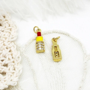 Macro detail of 18K gold plated lipstick charms with colorful enamel and micro zircon