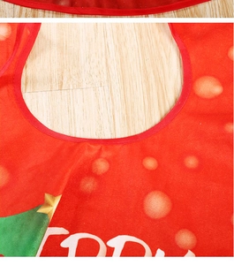 Close-up of red velvet Christmas tree skirt with Merry Christmas print and stitching