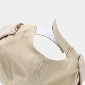 Detail of khaki cotton beanie showing the adjustable hook-and-loop strap and clean stitching