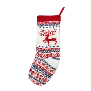 Knitted Christmas stocking with red reindeer and snowflake patterns for holiday gifts