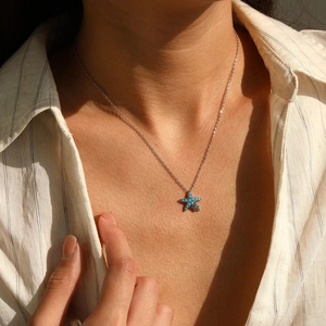 S925 sterling silver starfish necklace with turquoise pendant on woman's neck
