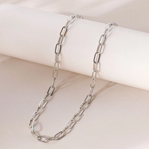 Detail of silver safety pin link chain necklace with polished 18K gold plating finish
