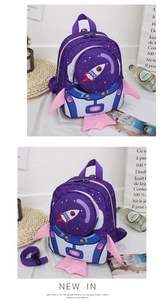Detail view of purple space astronaut backpack with cartoon rocket and pink wings for kids
