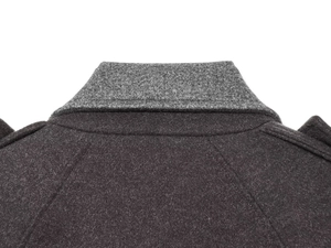 Detailed macro view showing the high-quality grey wool fabric and collar stitching of the coat