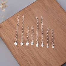 Detailed S925 sterling silver extender chains with heart and teardrop pendants on wood