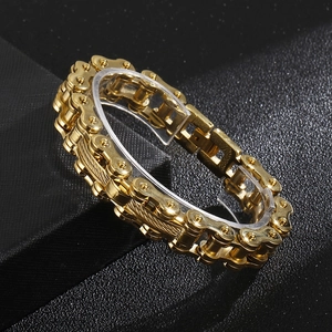 Polished gold stainless steel bike chain bracelet displayed on a dark textured background
