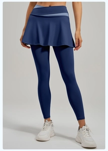 Detail of high-waist 2-in-1 yoga leggings featuring a navy blue crossover waist and skirt