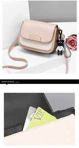 Detail of color-block crossbody bag featuring internal card slots and metal logo