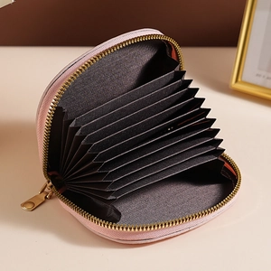 Pink textured shell accordion card holder with multiple slots and golden metal zipper