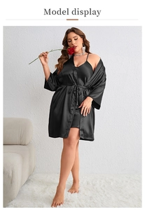 Detail of elegant black silk satin pajama set with lace-up robe and slip nightdress