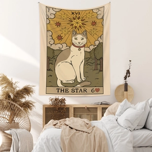 Detail of The Star Tarot cat tapestry in a cozy bohemian bedroom wall decor setting