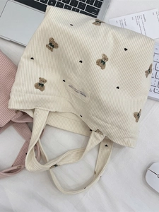 Minimalist beige corduroy tote bag with cute brown bear and black heart embroidery detail