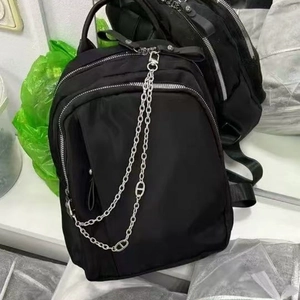 Black nylon backpack with silver metal decorative chain and multi-zipper detail