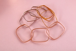 Top view of square stackable metal bangles in gold silver and rose gold finishes