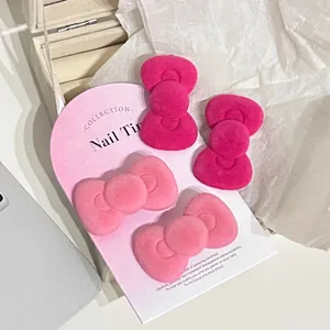 Pink flocked bow hair clips set with soft texture displayed on jewelry card