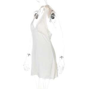 Detailed view of white satin halter dress featuring delicate lace trim and V-neckline