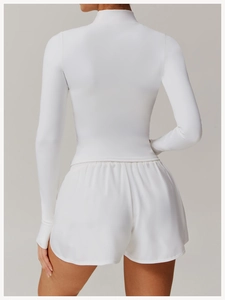Rear view of tight white long sleeve yoga top and high-waist shorts set for women